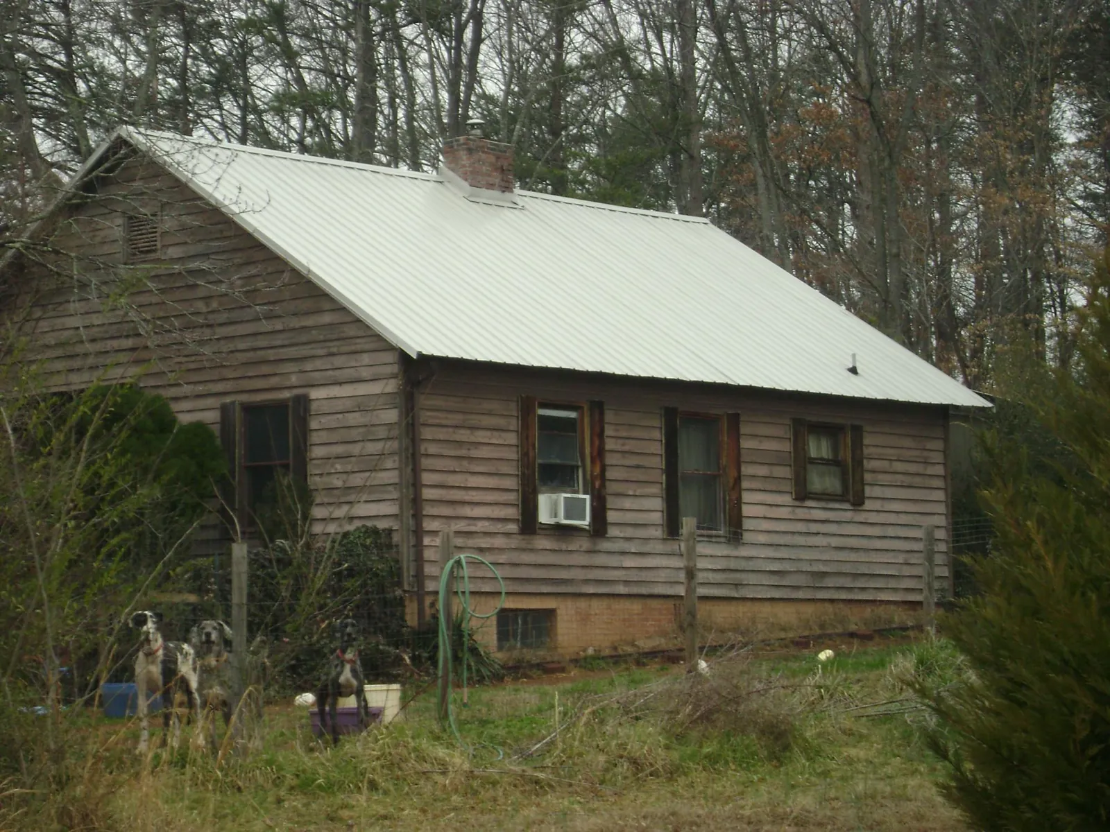 White metal roof on an old wood sided farmhouse, from a Metal Roof Installation job in Blairsville